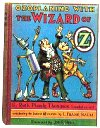 #33 Ozoplaning with the Wizard of Oz
									The Wizard decides to create ozoplanes for his friends which can fly into the stratosphere. The Wizard, Dorothy, the Cowardly Lion and the Scarecrow take one ozoplane, called the Ozpril, and go to the Red Top Mountains. The other group: Tin Woodman, Jellia Jamb and the Soldier with the Green Whiskers take the Oztober to the sky city of Stratovania. The phrase 'The Wizard of Oz' was included in the title to coincide with the release of MGM film The Wizard of Oz the same year the book was published.